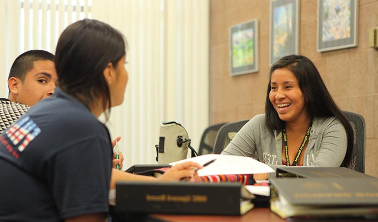 Upward Bound students sitting at a table.